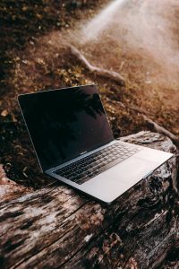 macbook pro on a log